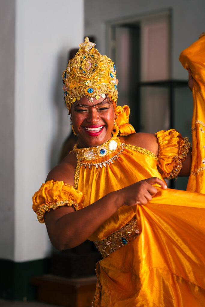 Woman dancing and smiling at Casa de Africa in Havana, Cuba. 