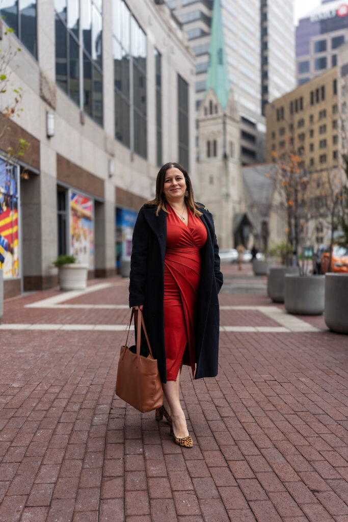 Street photo of a woman in a red dress.