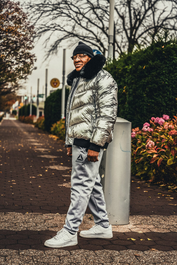 Street photo of a man dressed in all silver.